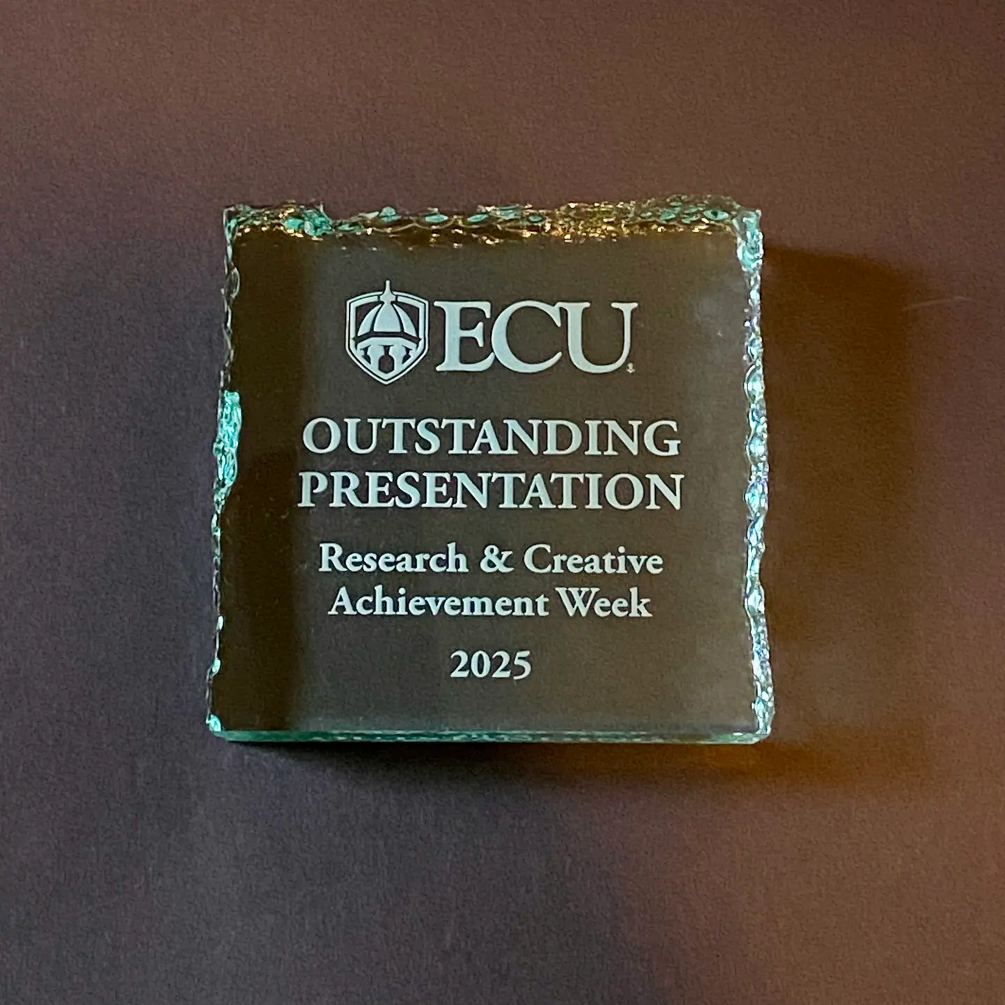 Glass award engraved: ECU Outstanding Presentation, Research & Creative Achievement Week 2025