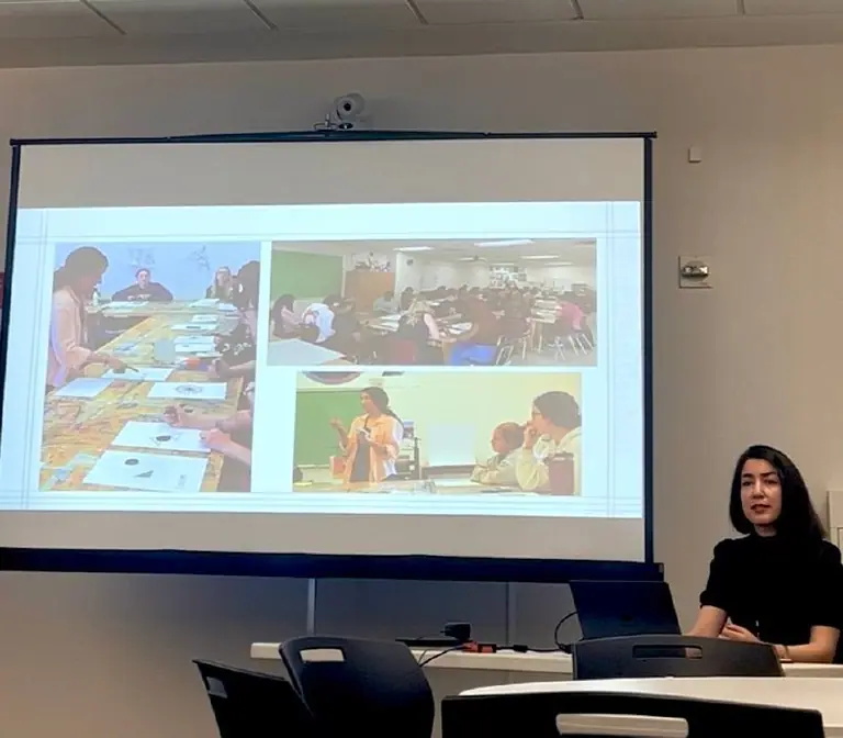 Narges Sedaghat presenting classroom photographs of students composing with layered paper