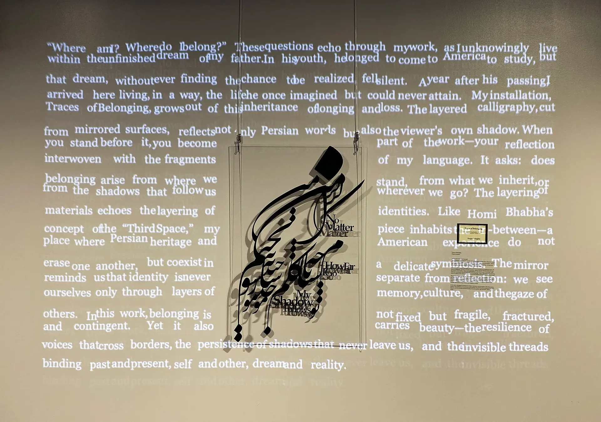 The suspended calligraphy against projected paragraphs of English text