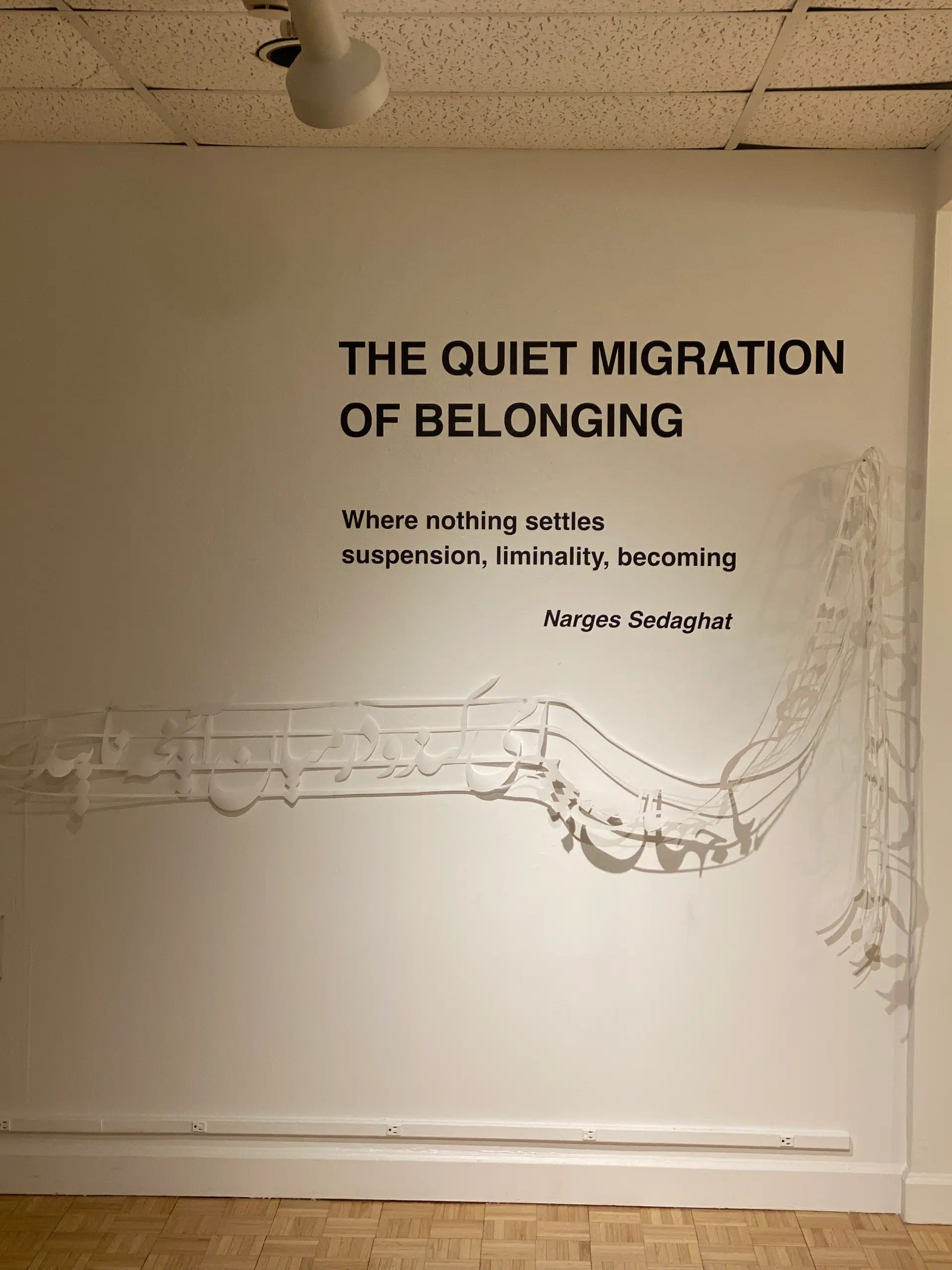 Wall title: The Quiet Migration of Belonging — Where nothing settles. Suspension, liminality, becoming. Narges Sedaghat
