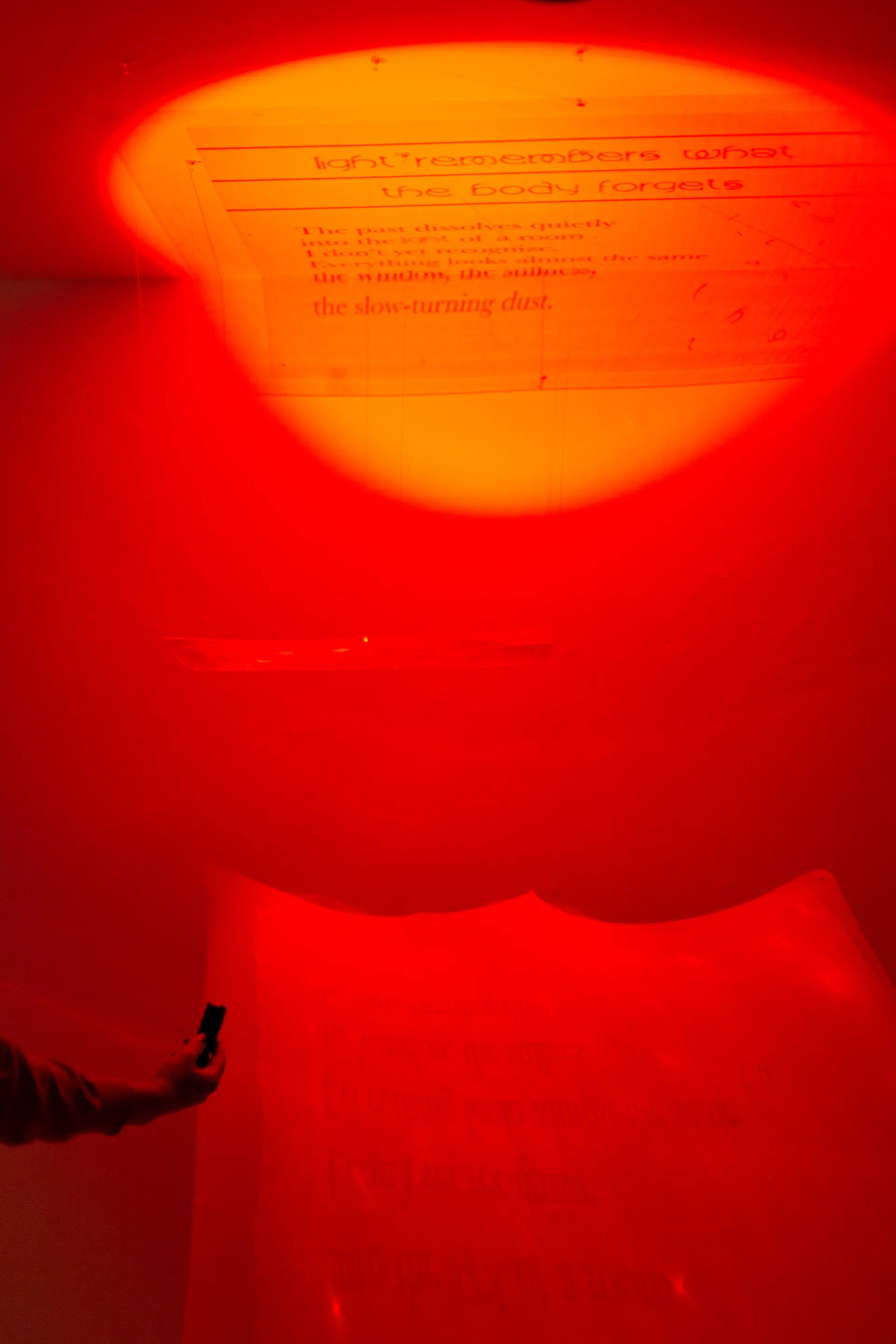 Suspended text sheets glowing red and orange, seen from below